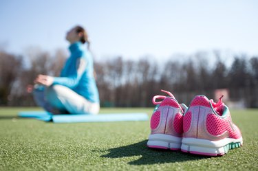 woman practicing yoga in a park