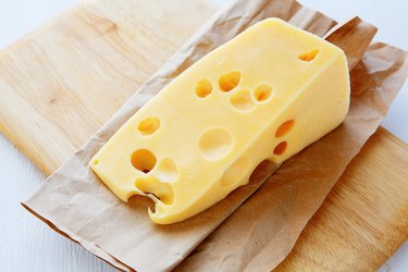 Why do some types of cheese have holes