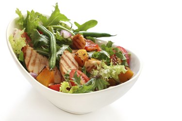 A grilled chicken salad in a bowl