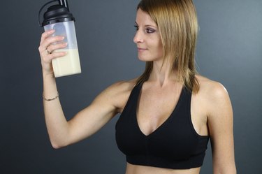beautiful woman looking a protein shake