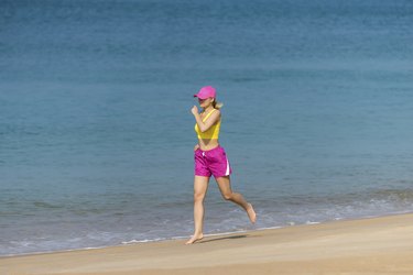 Healthy Woman running on beach