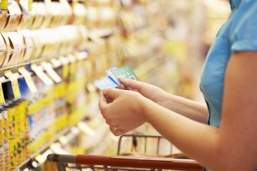 Woman In Grocery Aisle Of Supermarket