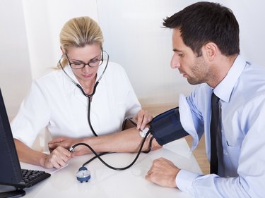 Doctor taking a patients blood pressure