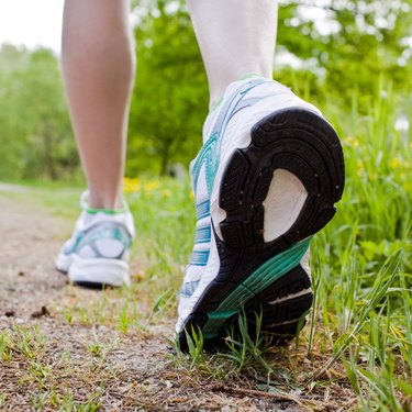 Woman walking cross country and trail in spring forest