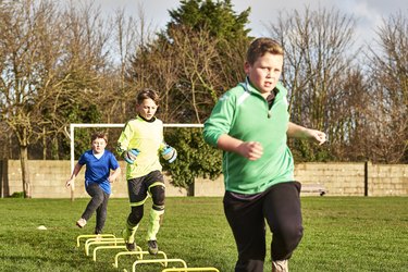 Children's football team running drills