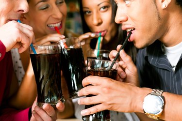 Friends drinking soda in a bar