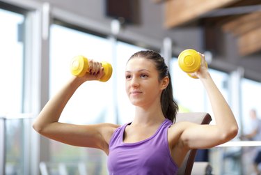 Young woman lifting weights