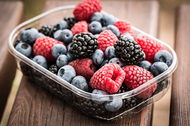 Foods that are good to eat after hysterectomy include box full of berries on wooden slat background