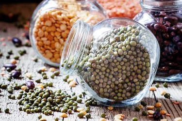 Green lentils in a glass jar, mix beans