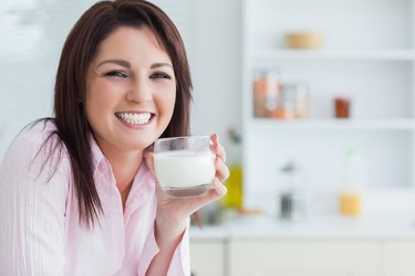 Portrait of woman with glass of milk