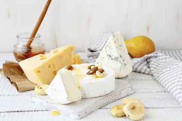 Different cheeses on a cutting board