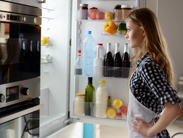 Woman with open fridge