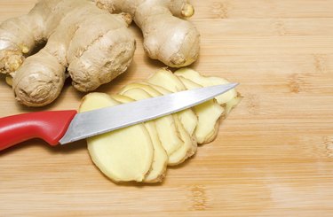 Ginger root on a bamboo chopping block