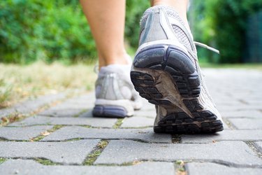 Close up of walking or cross-training sneakers on a cobblestone path