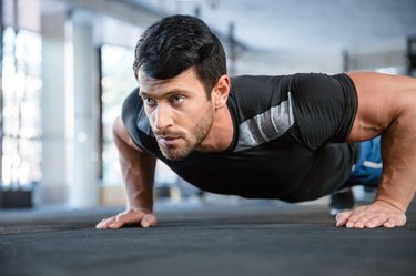 Man doing push ups in gym