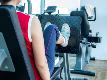 Woman exercising with machine in gym