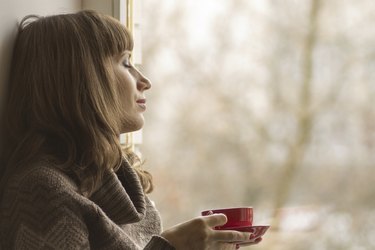 Beautiful girl dreaming with cup of coffee