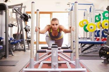 Woman working out using equipment at a gym