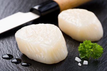 Scallops on black stone plate