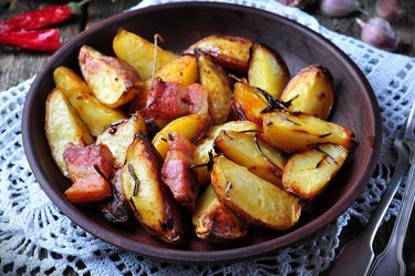 Baked potato with bacon, rosemary, olive oil and sea salt