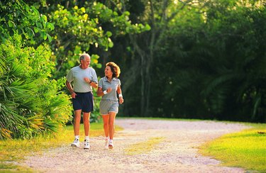 Hispanic senior couple jogging