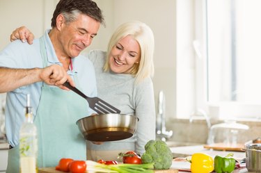 Happy mature couple making dinner together