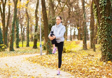 Young woman with headphones preparing for a jogging