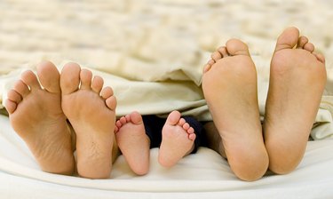 Parents feet with their new born Child