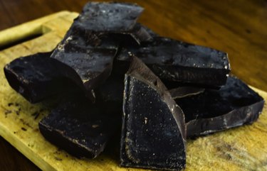 Dark chocolate bar on rustic wood table