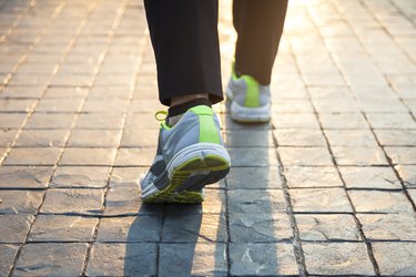 Woman walking on trail outdoor with sunlight