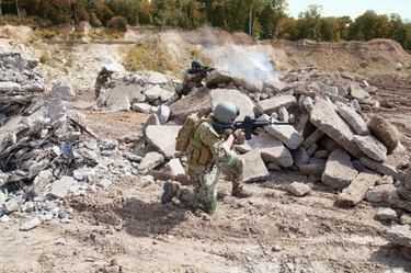 Members of Navy SEAL Team with weapons in action