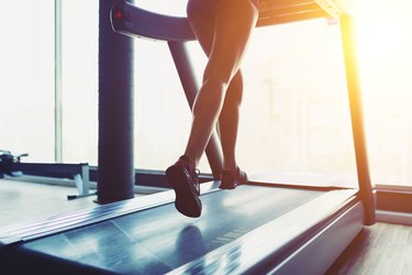 Fitness girl running on treadmill