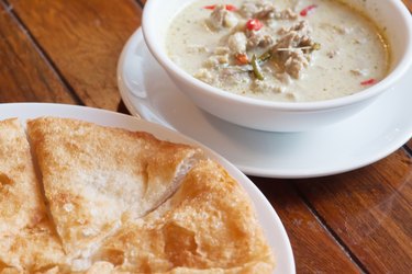 Thai food: green curry with coconut milk and fried Roti