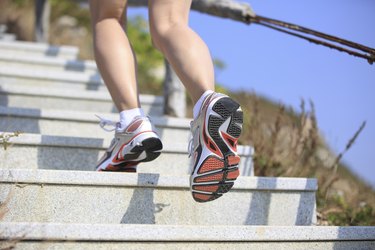 woman running up on mountain stairs