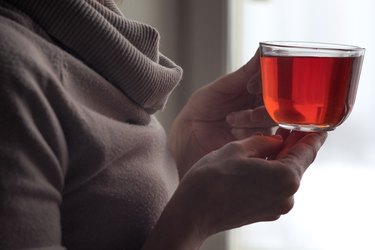 Cup of tea in the woman hands