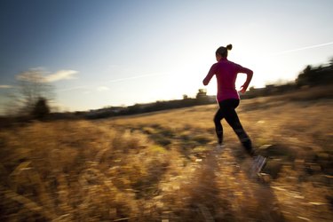 Young woman running outdoors in a city park