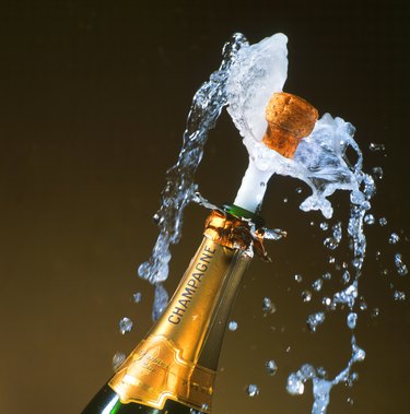 a champagne bottle with its cork shooting out