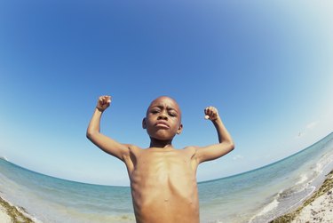 A Strong Girl With Big Muscular Arms On A Beach Stock Photo