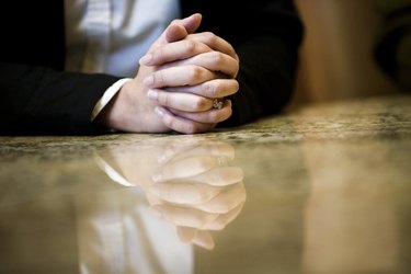 Close-up of human hands on conference table in an office