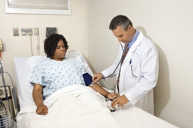 Doctor taking patient's blood pressure