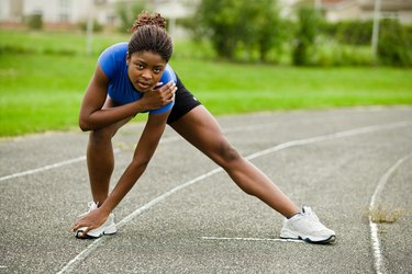 Woman stretching on track