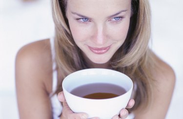 Woman holding cup of tea