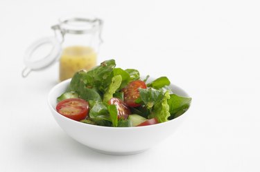 Green salad in a white bowl, studio shot