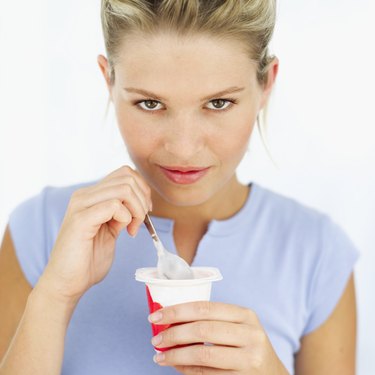 woman eating a yoghurt