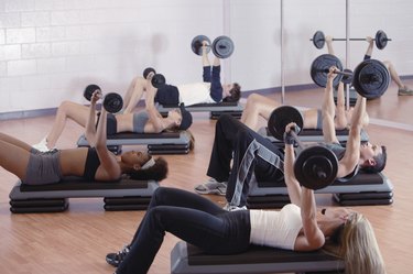 Exercise class lifting weights at gym