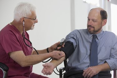 Doctor measuring patient's blood pressure