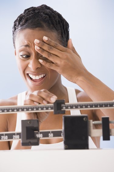 African American woman weighing self