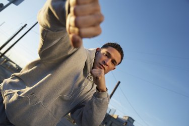 Portrait of man in fighting stance outdoors