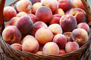 Fresh clean peaches in basket