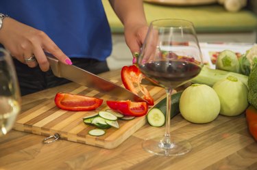Woman slicing bell pepper for a healthy salad.